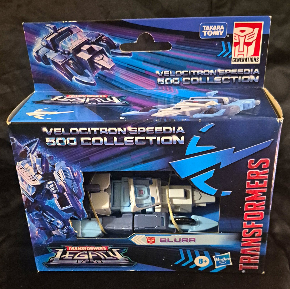 Transformers Legacy Velocitron Speedia 500 Blurr Deluxe Class IDW New In Box.