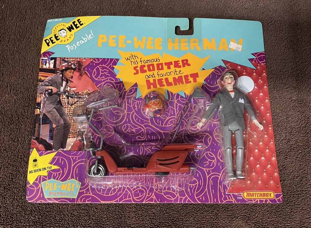 NEW SEALED IN PACKAGE PEE-WEE HERMAN WITH HIS FAMOUS SCOOTER AND FAVORITE HELMET