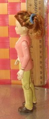 Doll, action figure, fem-character in pink top and white shirt with khaki/beige