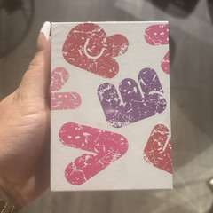 Multicolor Action Figure Box with Heart-Shaped Designs and Colorful Hand Designs
