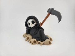 Chillin’ Grim Reaper Skeleton Figure on Skull Pile