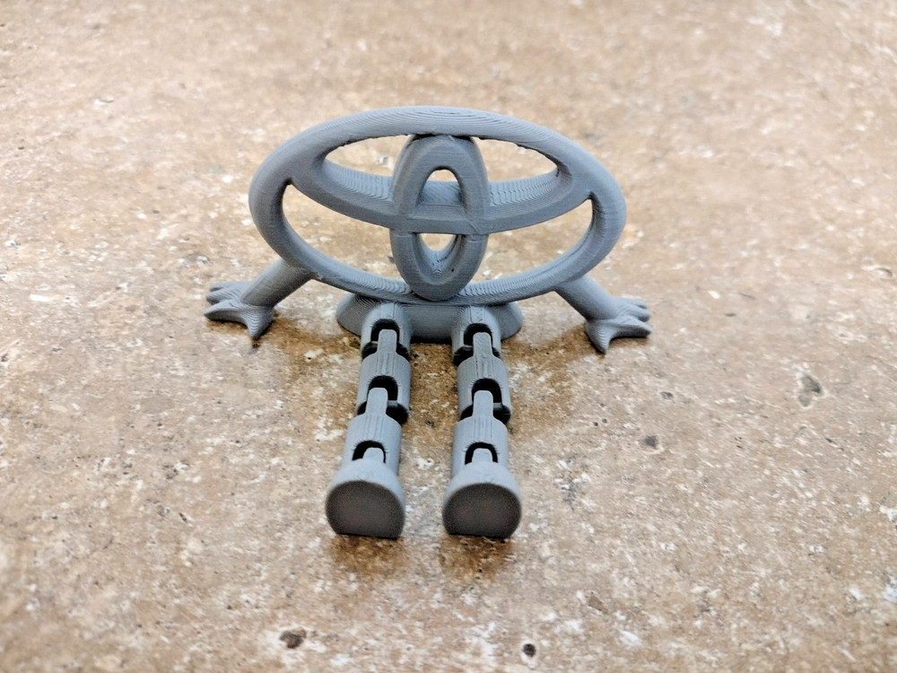 3D Printed Toyota Logo Articulated Desk Toy Figure Gray PLA Decor