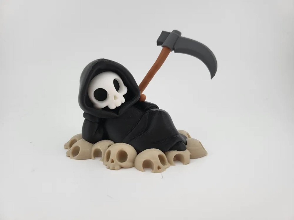 Chillin’ Grim Reaper Skeleton Figure on Skull Pile