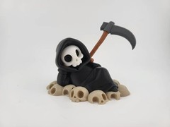 Chillin’ Grim Reaper Skeleton Figure on Skull Pile