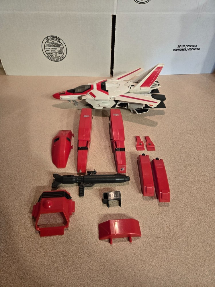 Vintage 1985 Transformers G1 Jetfire figure with accessory pieces.