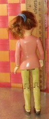 Doll, action figure, fem-character in pink top and white shirt with khaki/beige