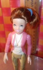 Doll, action figure, fem-character in pink top and white shirt with khaki/beige