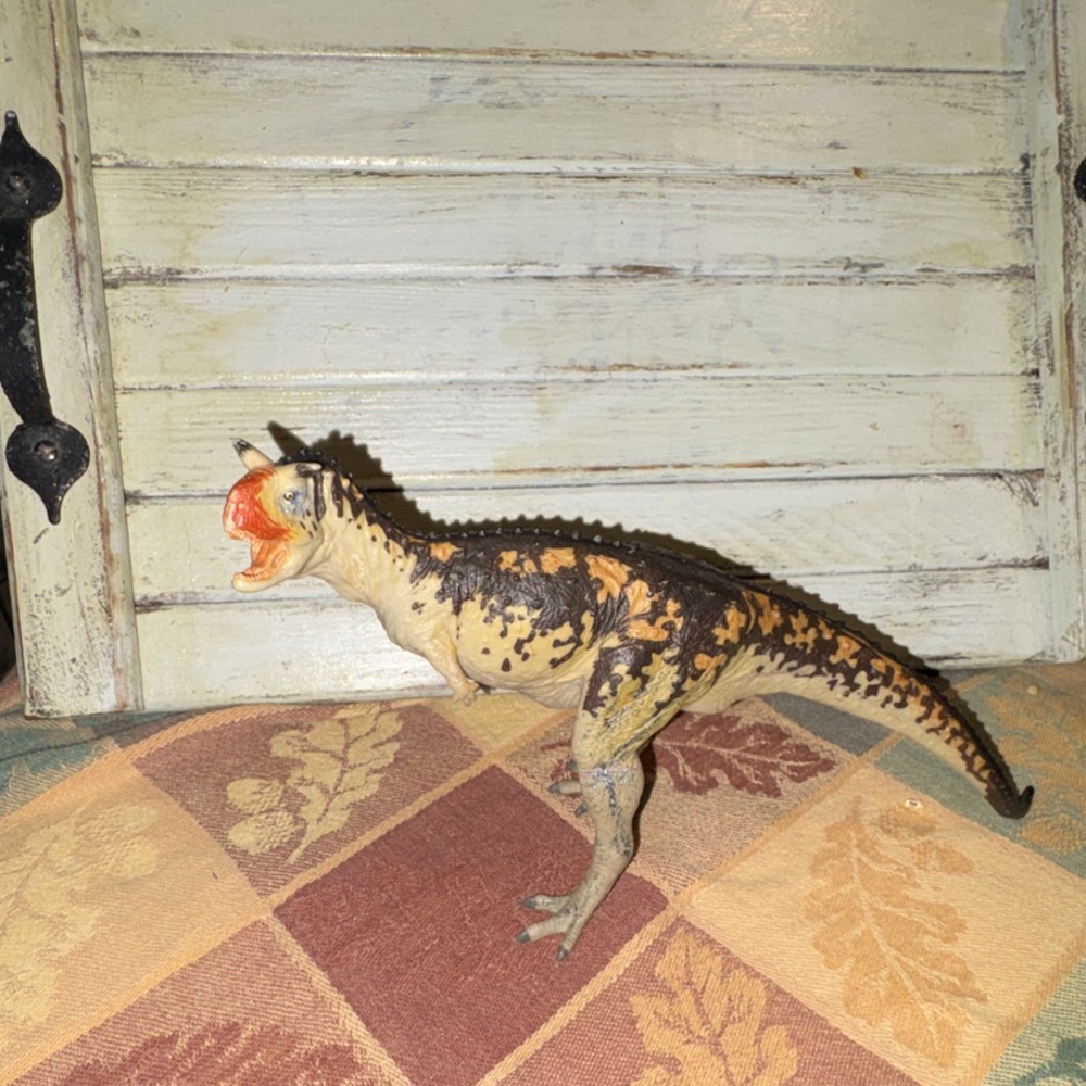 Carnotaurus action figure – orange & black plastic toy (7 inch)