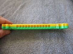 1975 Plastic Green/Yellow Toy Harmonica Have No Fear Underdog Is Here Lednardo