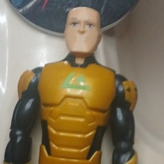Yellow & Black Plastic Action Figure w/ Green Chest Symbol, Flesh Accents