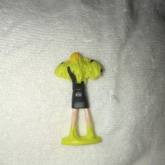 Plastic Figurine Toy Character in Black Dress with Green Base, Flesh Tone