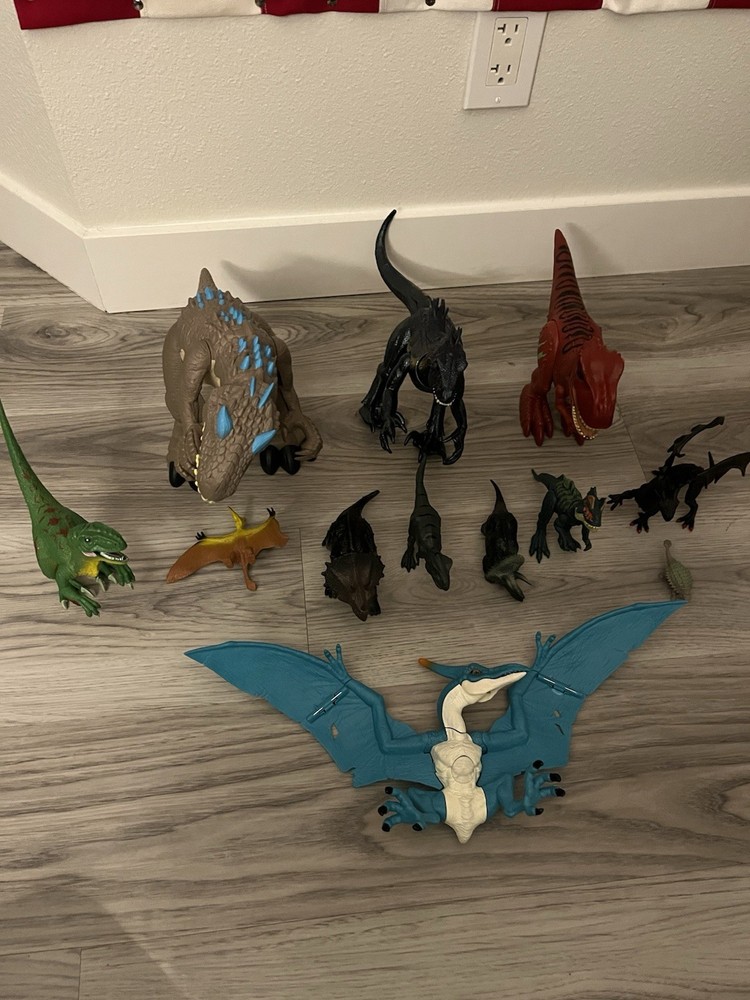 A collection of 12 dinosaurs, including both mechanical and standard models.
