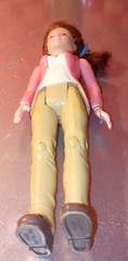 Doll, action figure, fem-character in pink top and white shirt with khaki/beige