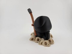Chillin’ Grim Reaper Skeleton Figure on Skull Pile